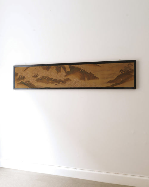 Long horizontal Japanese silk panel from around 1850 shown mounted on a white wall
