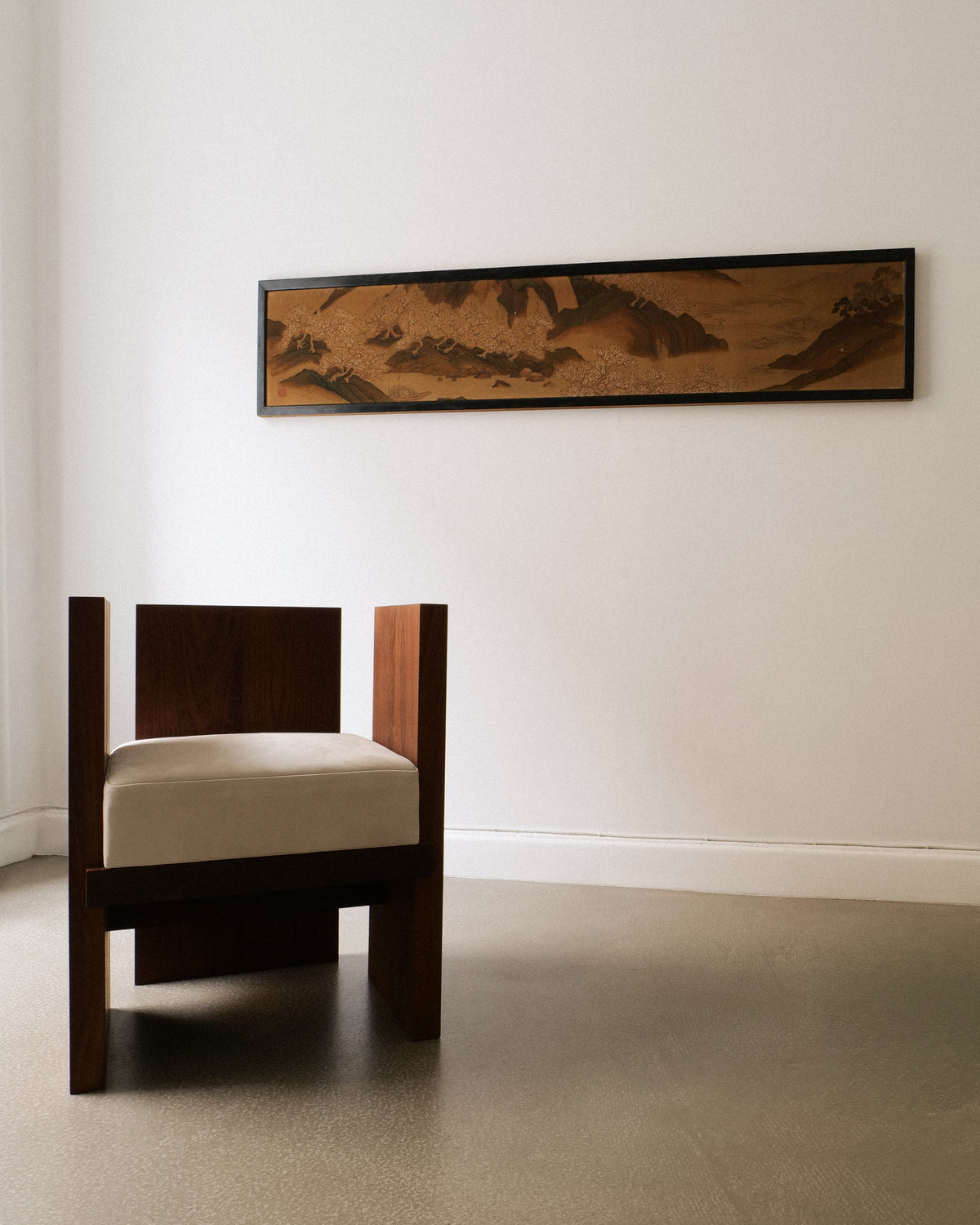 Antique Japanese silk panel displayed above Jesper Sundberg Örtegren's walnut wood chair in a minimal interior
