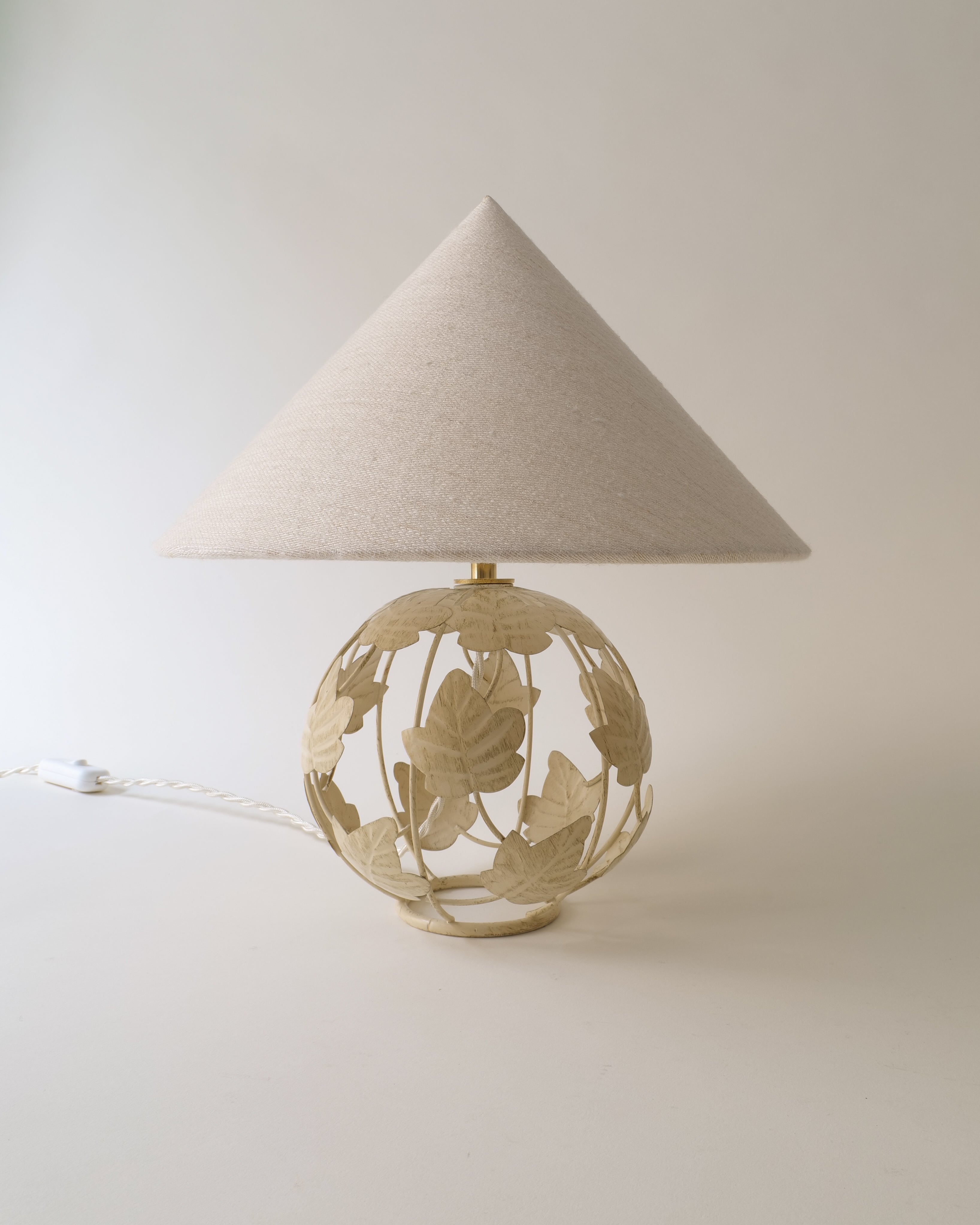 Decorative Art Nouveau table lamp with floral design on a plain background