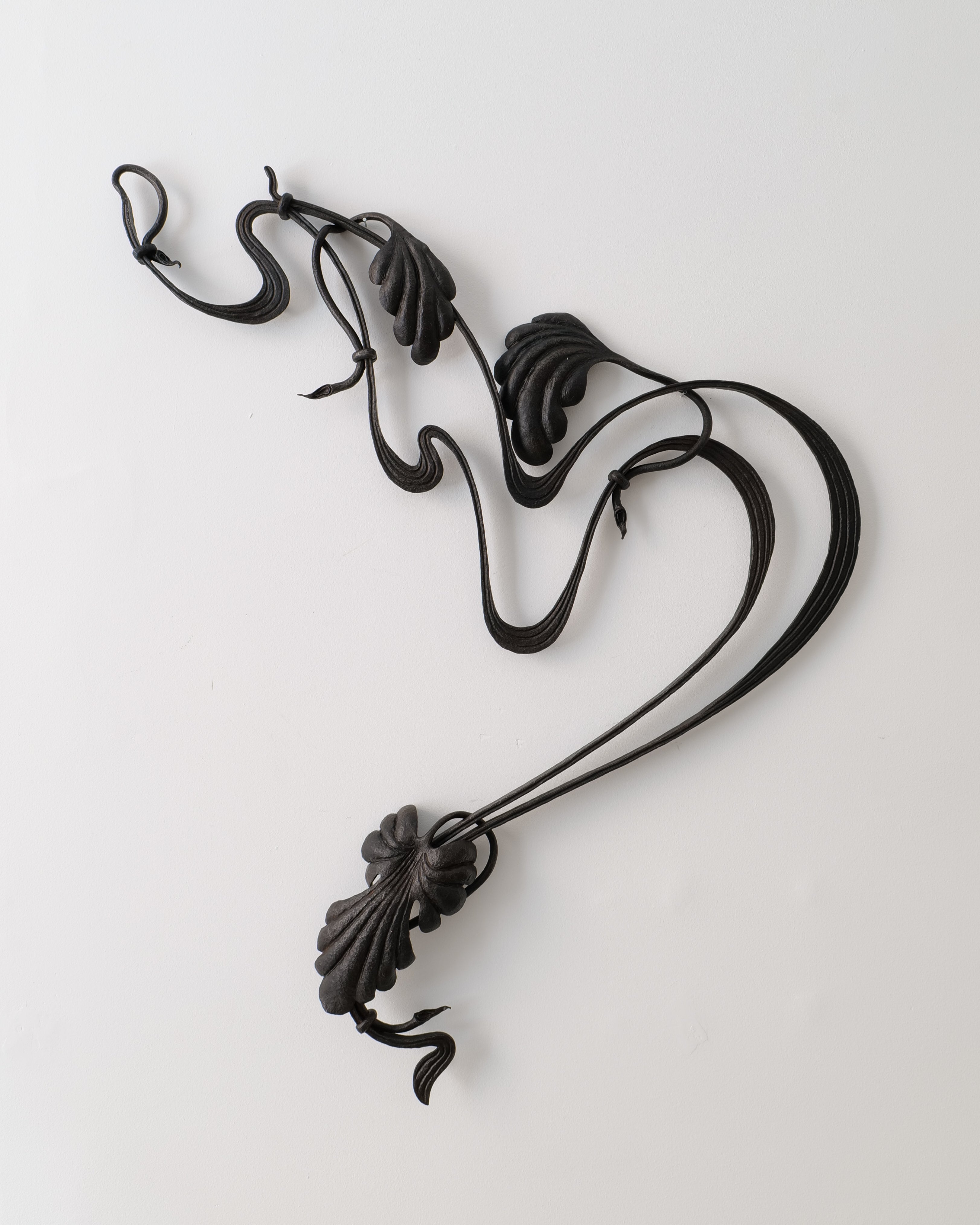 Decorative black metal object on a white background