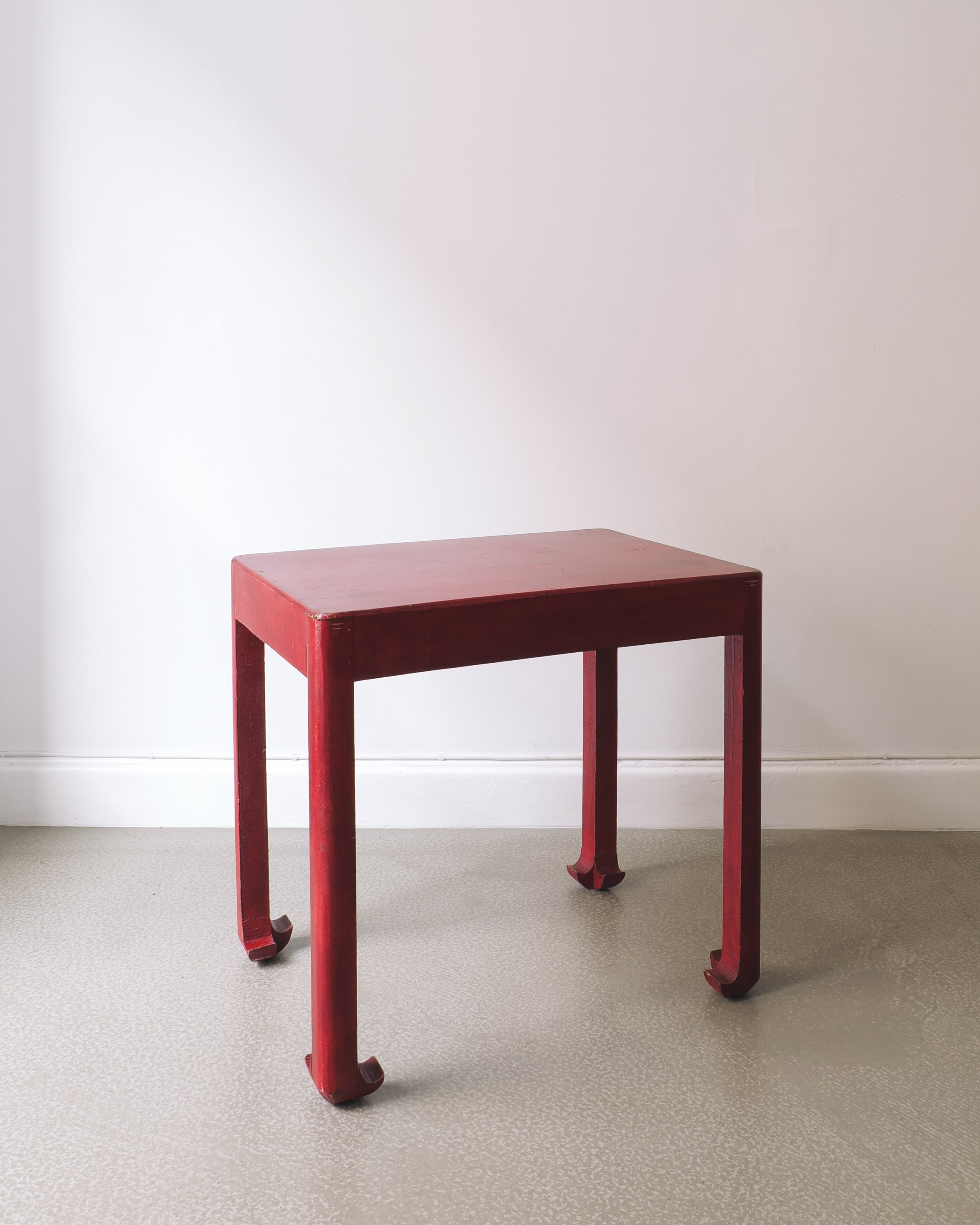 Red square table on a plain background