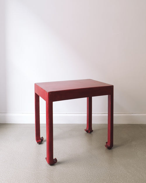 Red square table on a plain background
