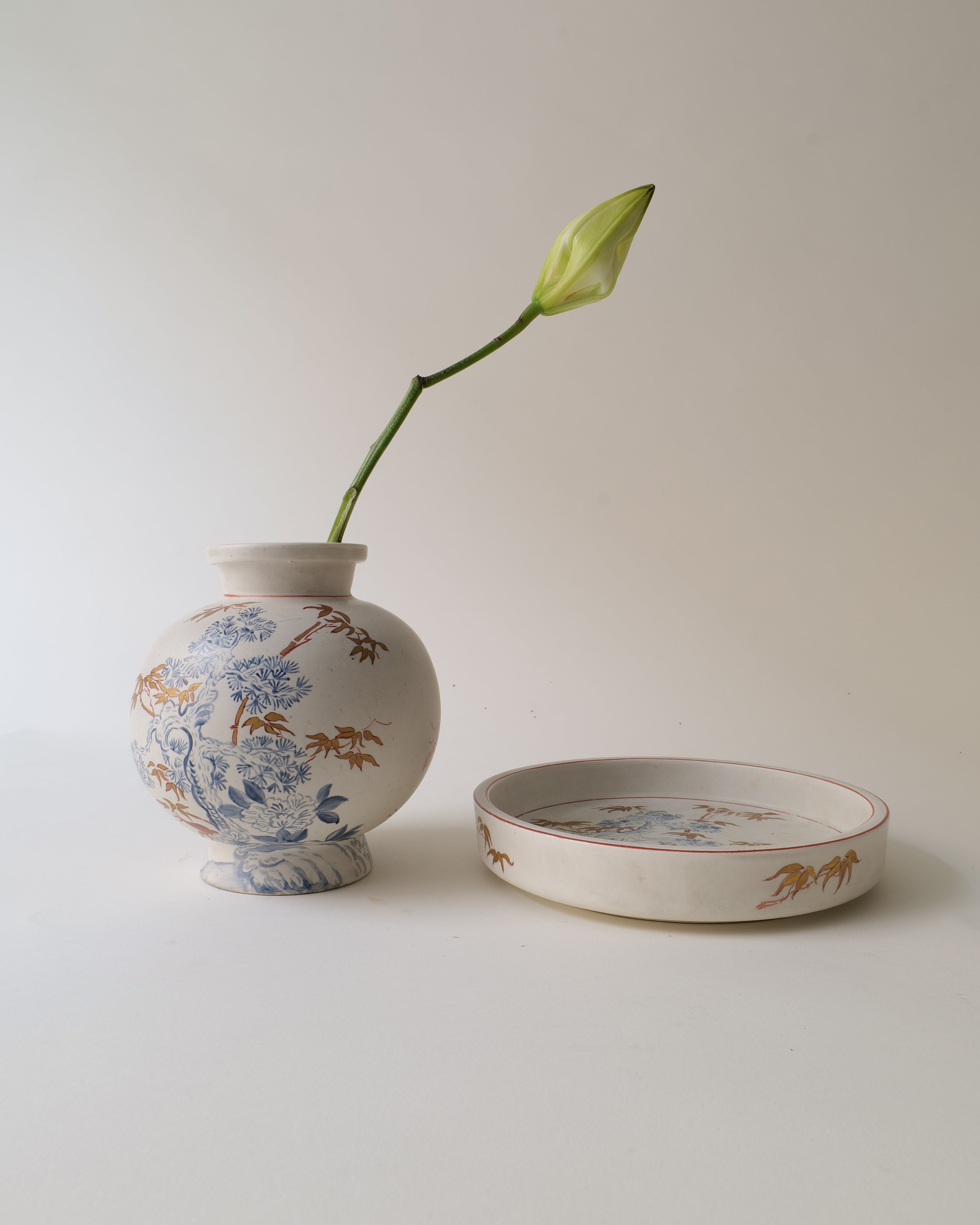 Ceramic vase by Wilheml Kåge with floral design and a matching bowl on a light background