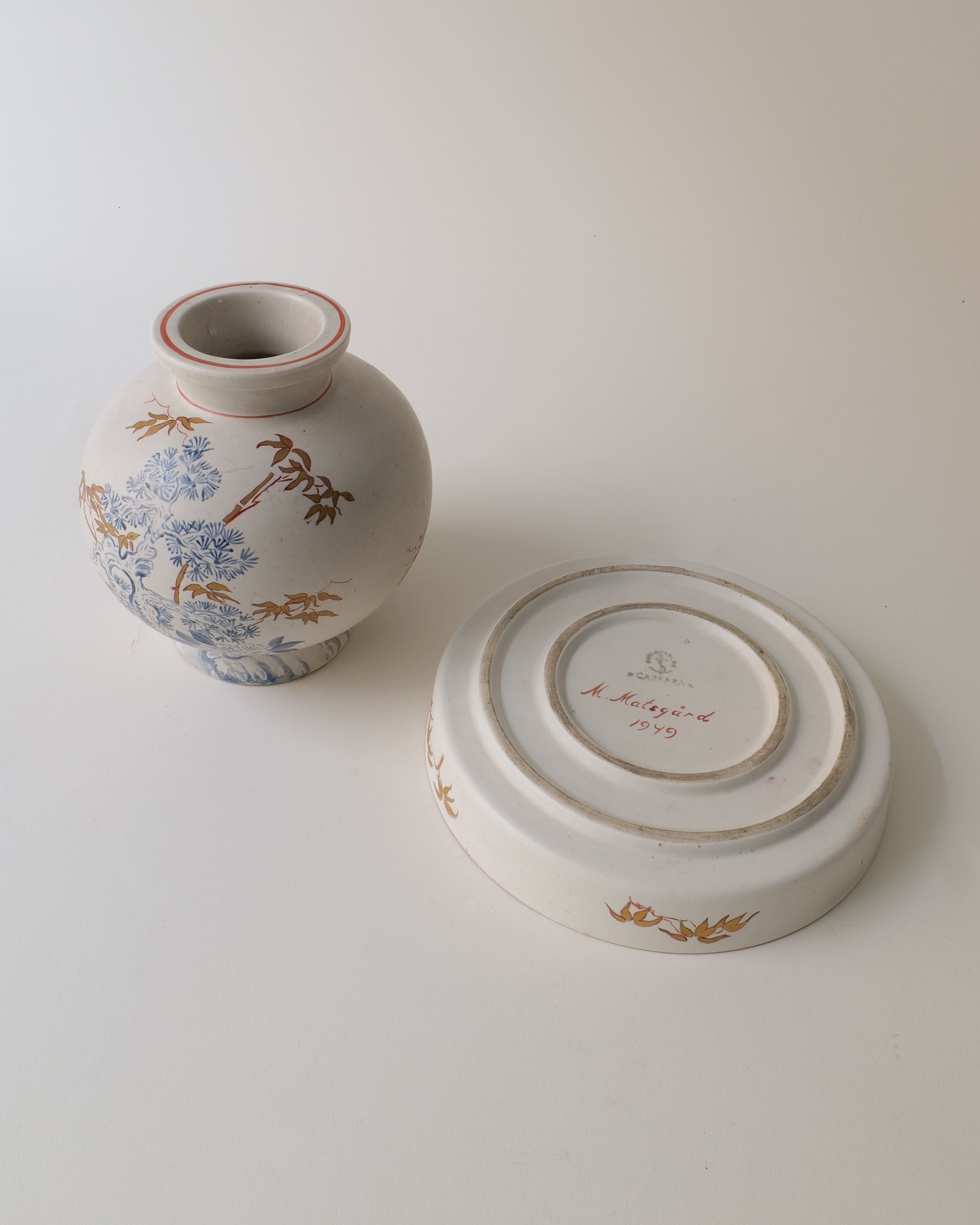 Ceramic vase by Wilheml Kåge with floral design and a matching bowl on a light background