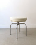 Charlotte Perriand LC8 swivel stool, Cassina c.1991, beige leather cushion and chrome quadripod base, full view