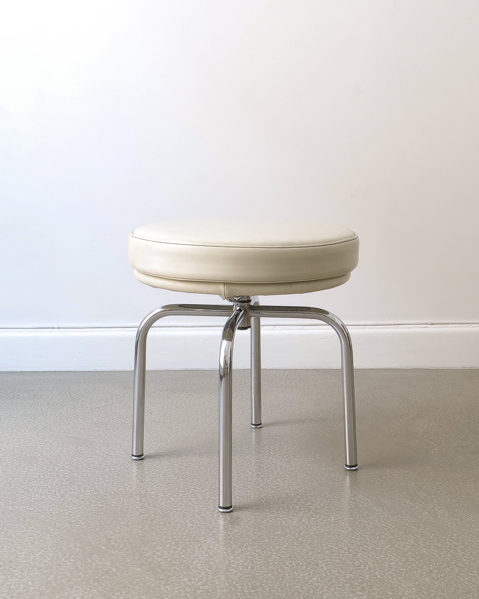 Charlotte Perriand LC8 swivel stool, Cassina c.1991, beige leather cushion and chrome quadripod base, full view