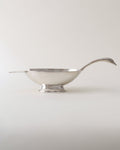 Silver gravy boat on a white background