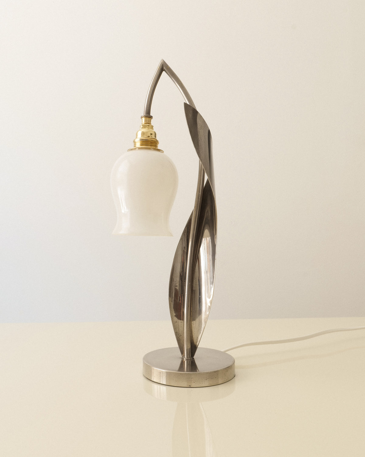 Chrome 1950s table lamp with sculptural leaf form and opaline lily-of-the-valley glass shade

