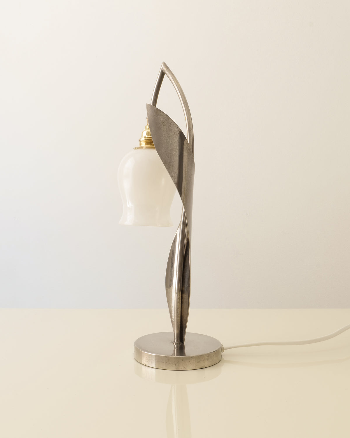 Side view of the 1950s chrome table lamp with curved stem and opaline glass shade
