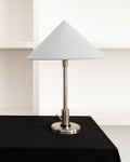 Danish Art Deco satin chrome table lamp with a pale blue conical linen shade and round base.