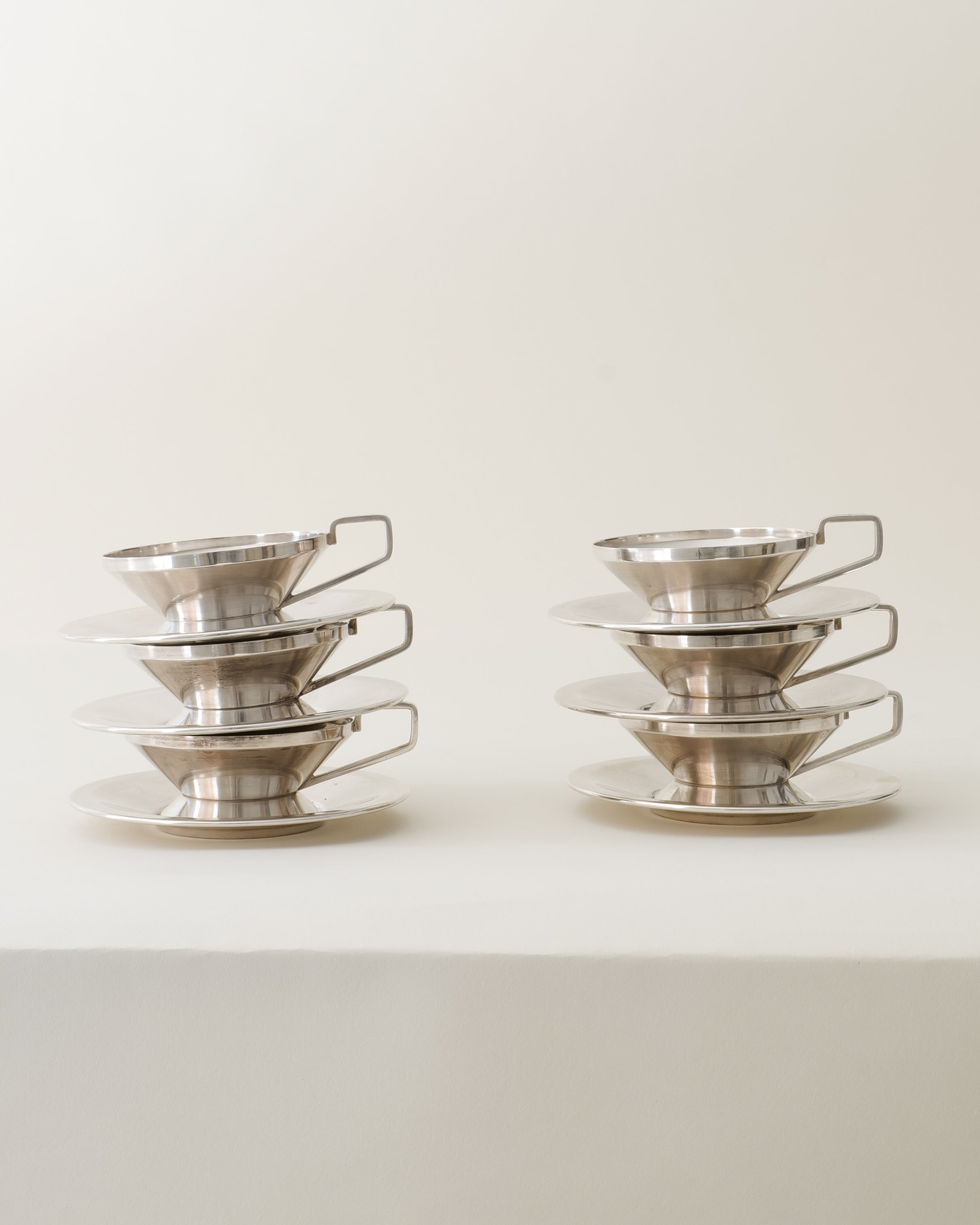 Gio Ponti silver-plated cups and saucers for Arthur Krupp Milano 1950s, two stacked sets of three, close-up
