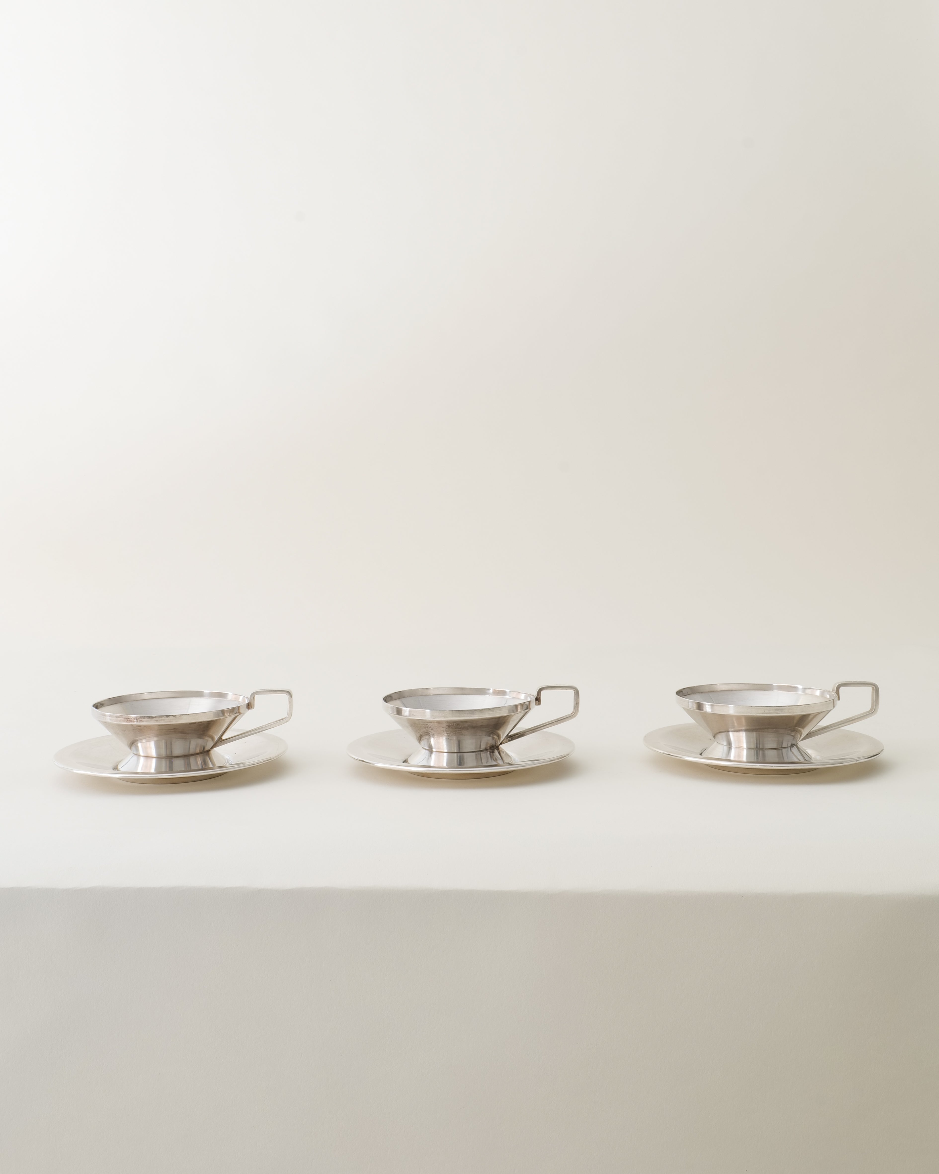 Gio Ponti Arthur Krupp cups and saucers, partial set arranged on surface, top-angled view
