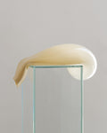  Glass Sculpture, 2023, Jesper Sundberg Örtegren, hand blown glass, cream organic form draped over glass podium, close-up side view