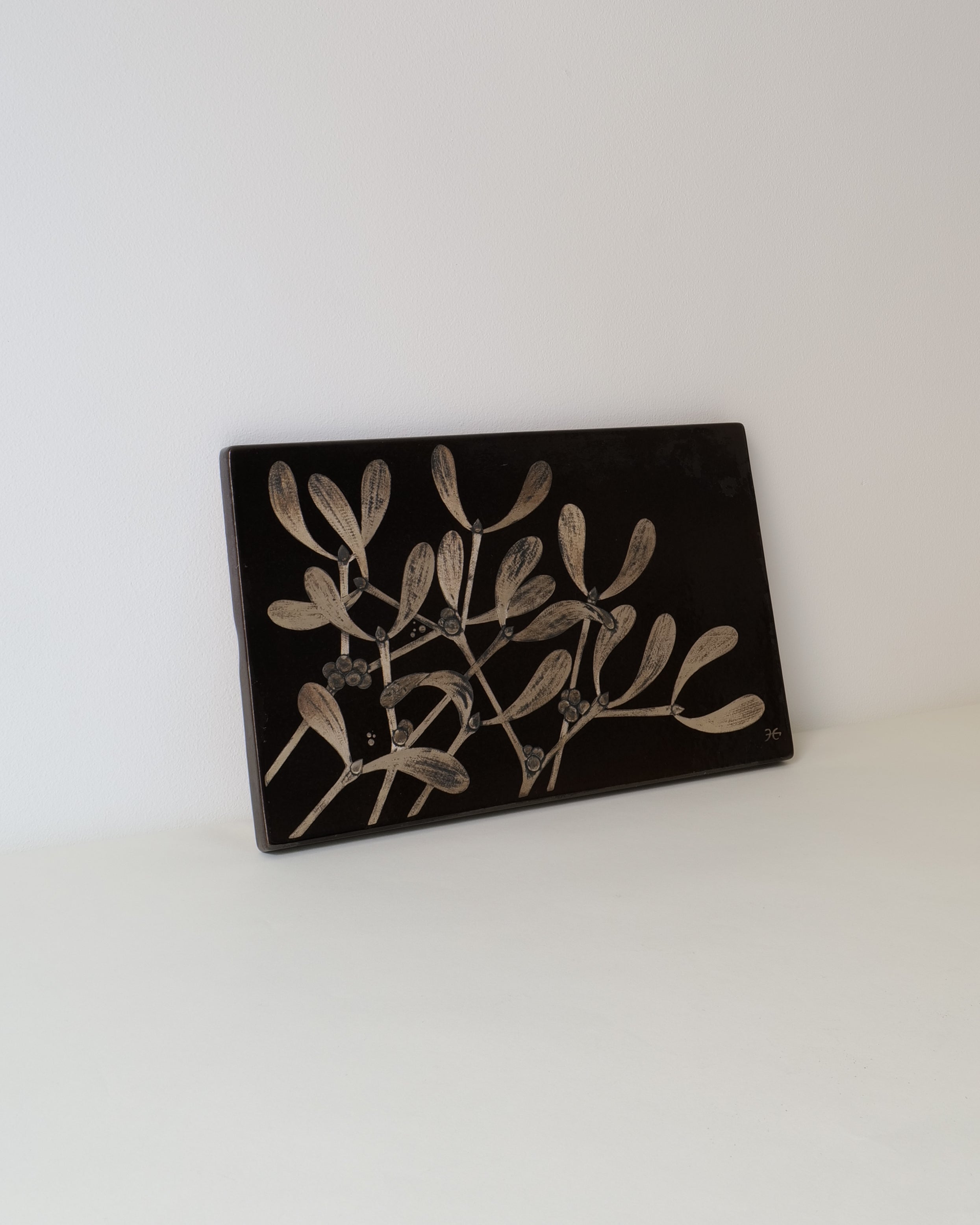 Decorative black box with white floral design on a white background