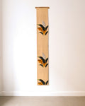 Japanese embroidered obi wall hanging with black, gold and orange botanical motifs
