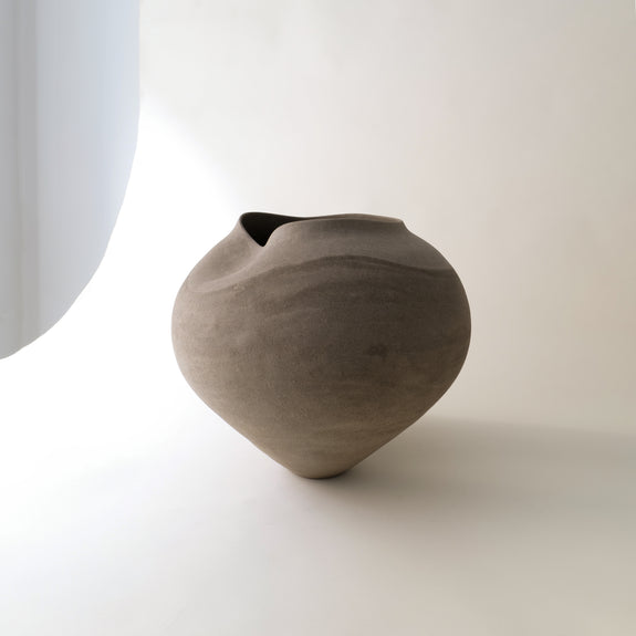 Grey ceramic vase on a white background