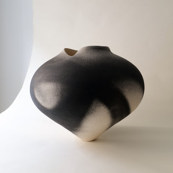 Black and white ceramic vase on a light background