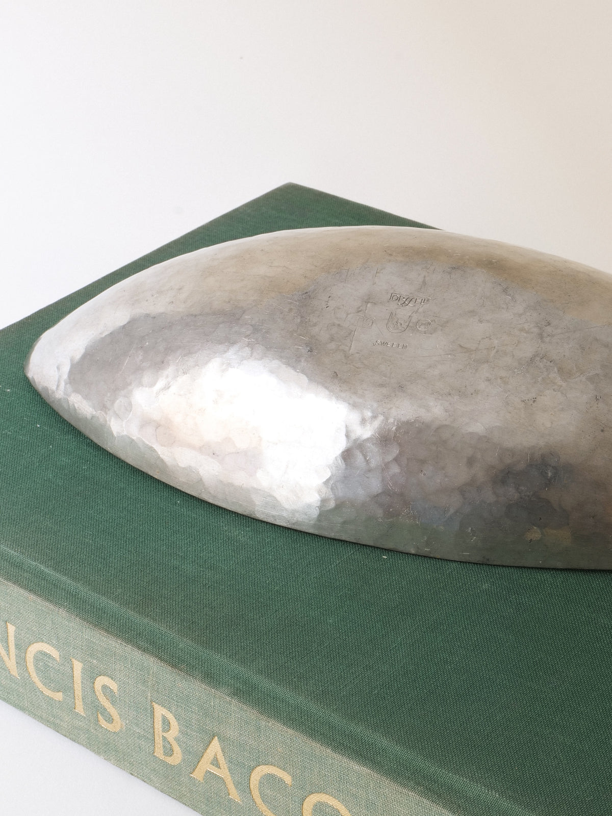 Close view of the underside and hammered surface of the Erik Torssell pewter bowl
