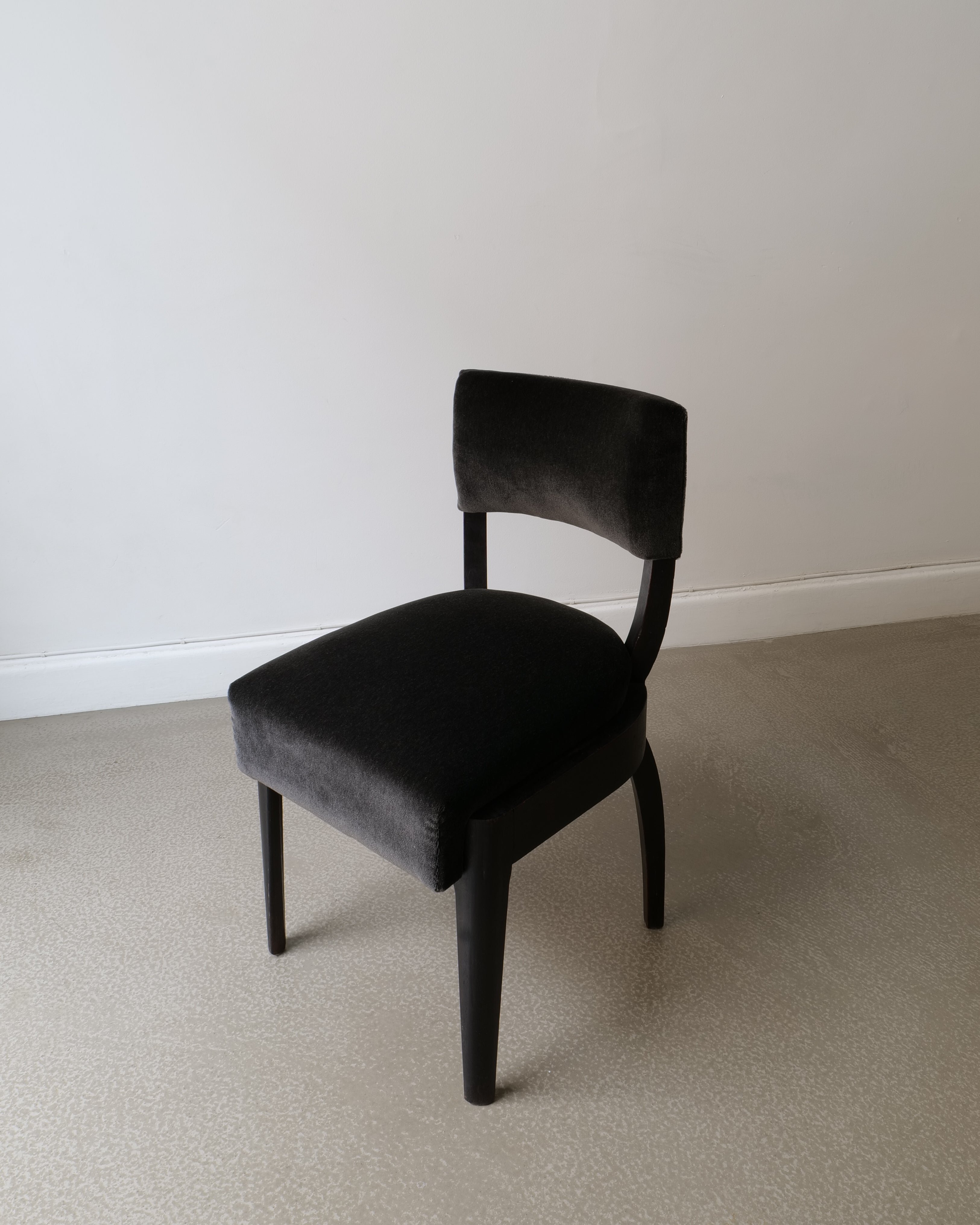 Front view of René Prou ebonised wood side chair with rounded back rail