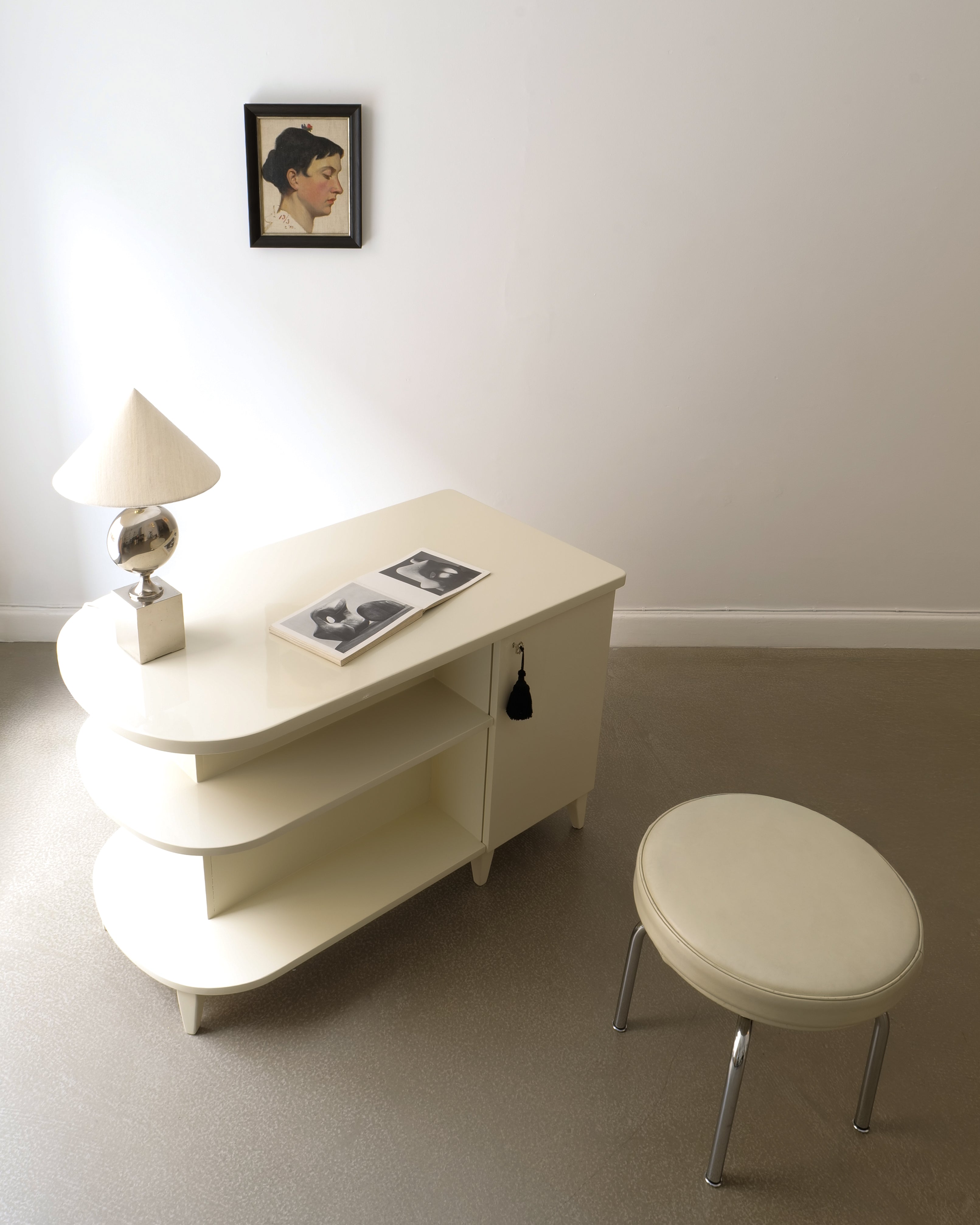 Swedish Art Deco lacquered desk, styled with table lamp and stool, room context view