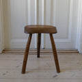 wood, stool, long tripod legs, hand carved heavy seat, curved shaped seat.